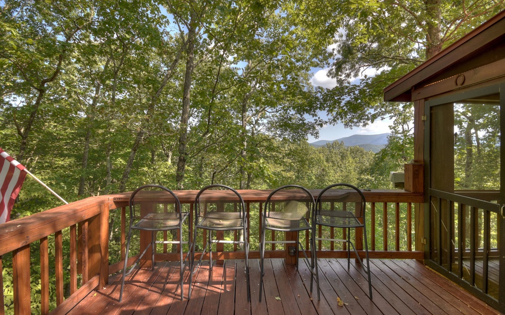 461 Cohutta Mountain Road Blue Ridge, GA 30513 - Photo 1 of 1 a view of a balcony with chairs and wooden fence