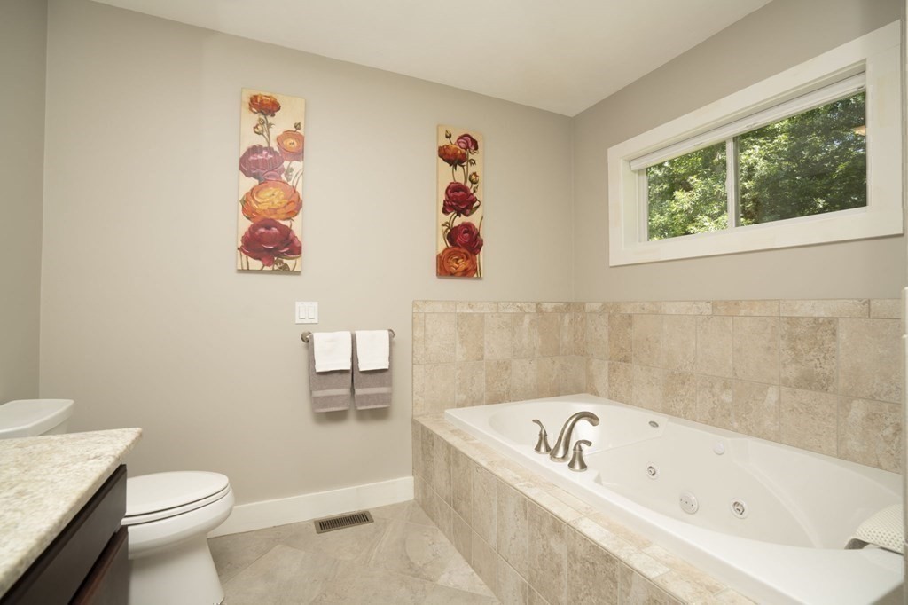 52 Upland Drive Middleboro, MA 02346 - Photo 15 of 40 a white bath tub sitting next to a white toilet