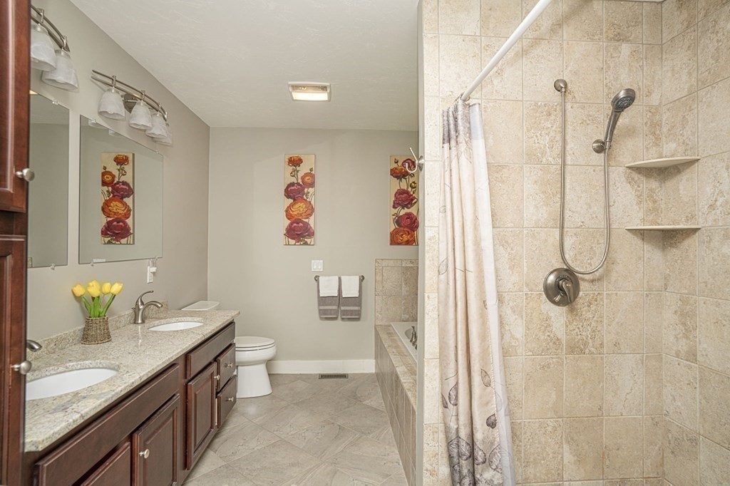 52 Upland Drive Middleboro, MA 02346 - Photo 16 of 40 a bathroom with a granite countertop sink a toilet and shower