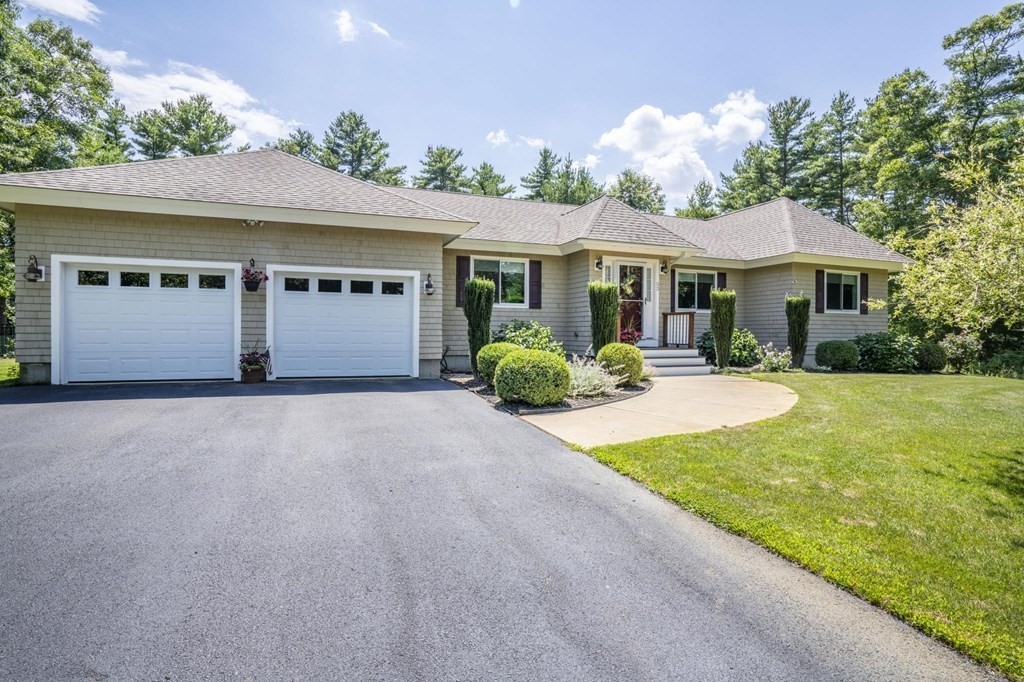 52 Upland Drive Middleboro, MA 02346 - Photo 2 of 40 a front view of a house with a yard and potted plants
