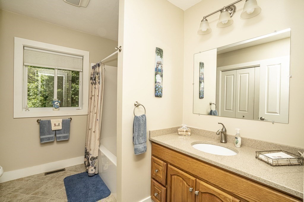 52 Upland Drive Middleboro, MA 02346 - Photo 23 of 40 a bathroom with a granite countertop sink and a mirror