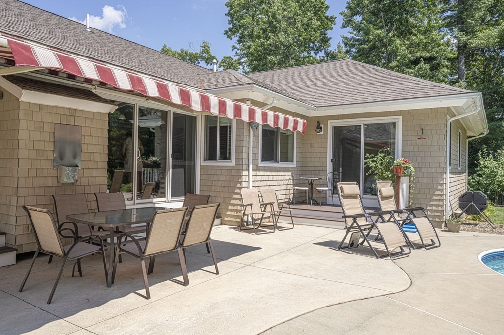 52 Upland Drive Middleboro, MA 02346 - Photo 28 of 40 a patio with a table and chairs and potted plants