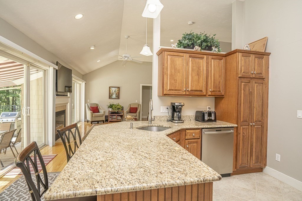 52 Upland Drive Middleboro, MA 02346 - Photo 7 of 40 a kitchen with sink a refrigerator and wooden cabinets