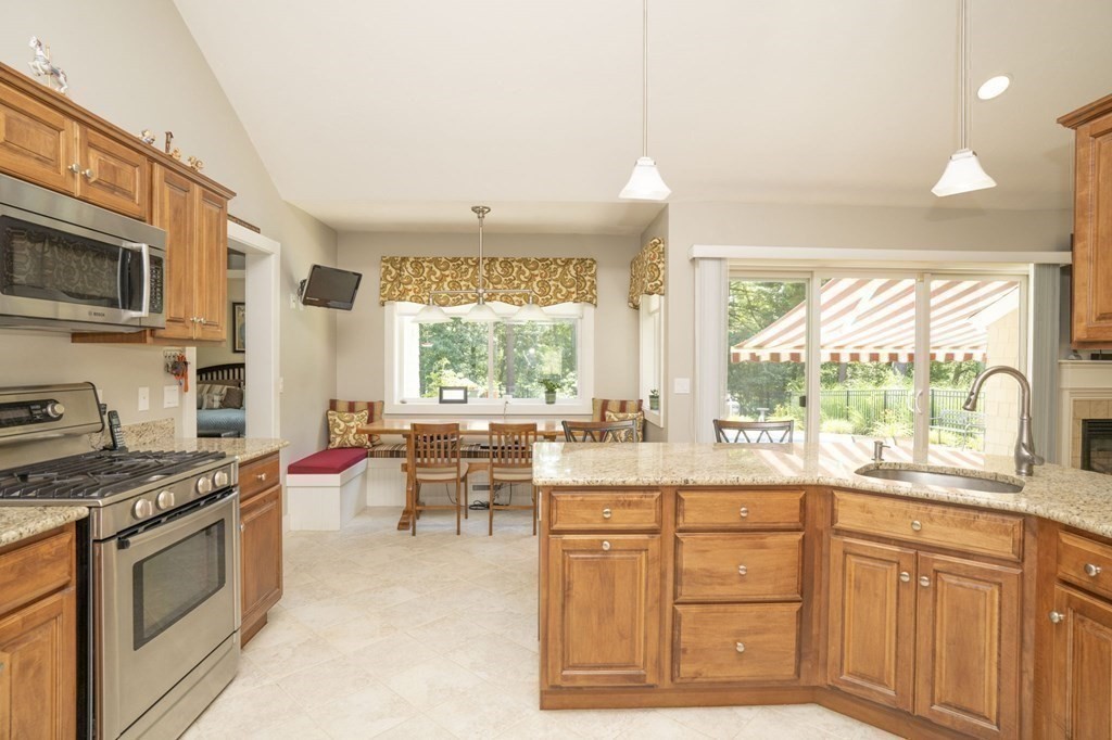 52 Upland Drive Middleboro, MA 02346 - Photo 8 of 40 a kitchen with kitchen island granite countertop a stove and a sink