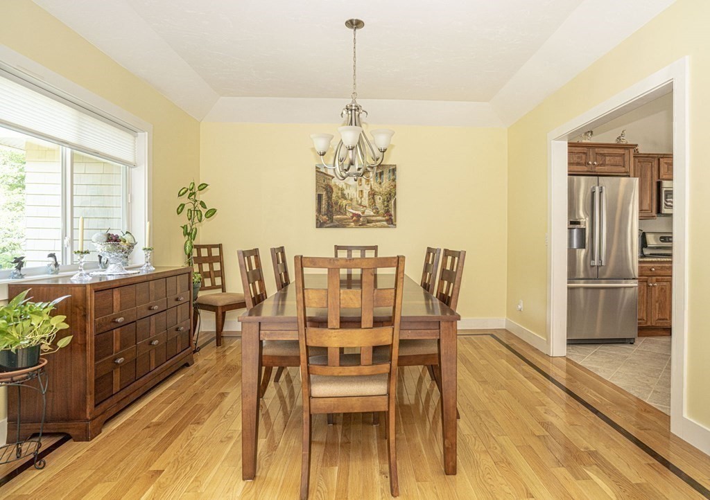52 Upland Drive Middleboro, MA 02346 - Photo 10 of 40 a dining room with stainless steel appliances kitchen island granite countertop a dining table chairs and granite counter tops