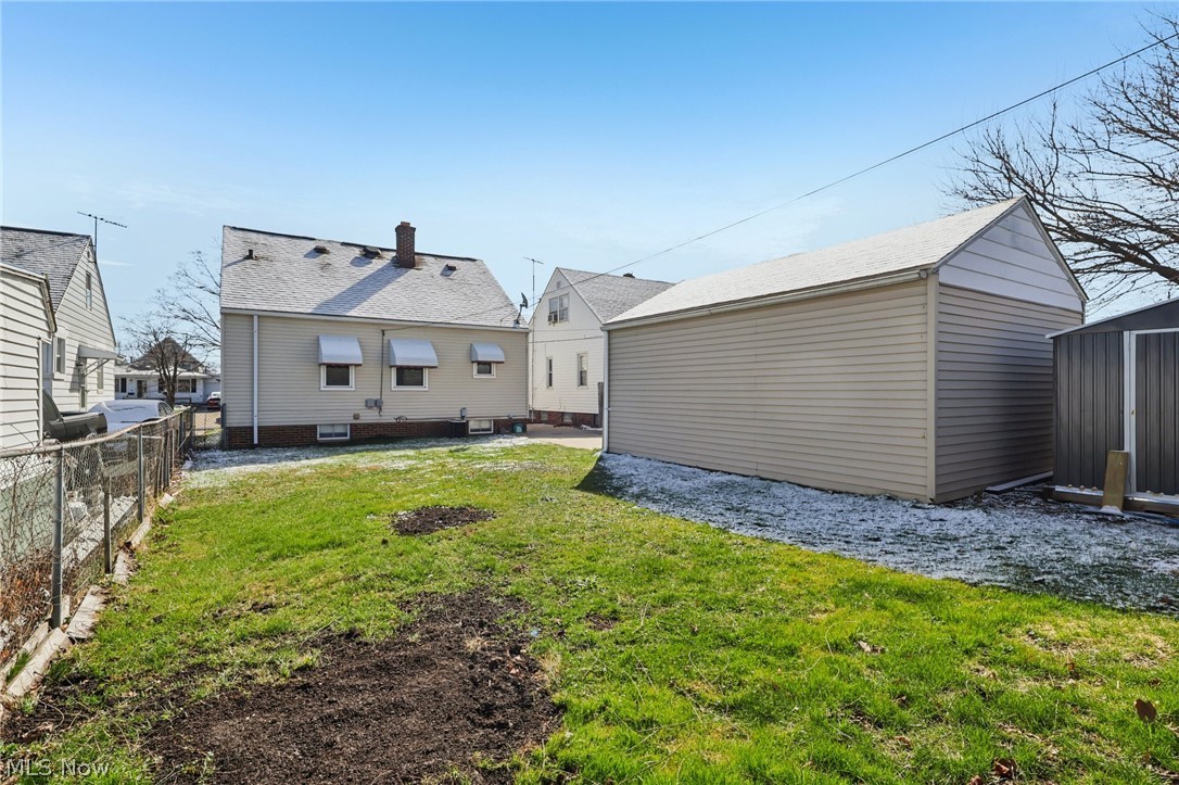 4252 Ridgeview Road Cleveland, OH 44144 - Photo 31 of 37 Rear view of house featuring a storage shed and a patio area