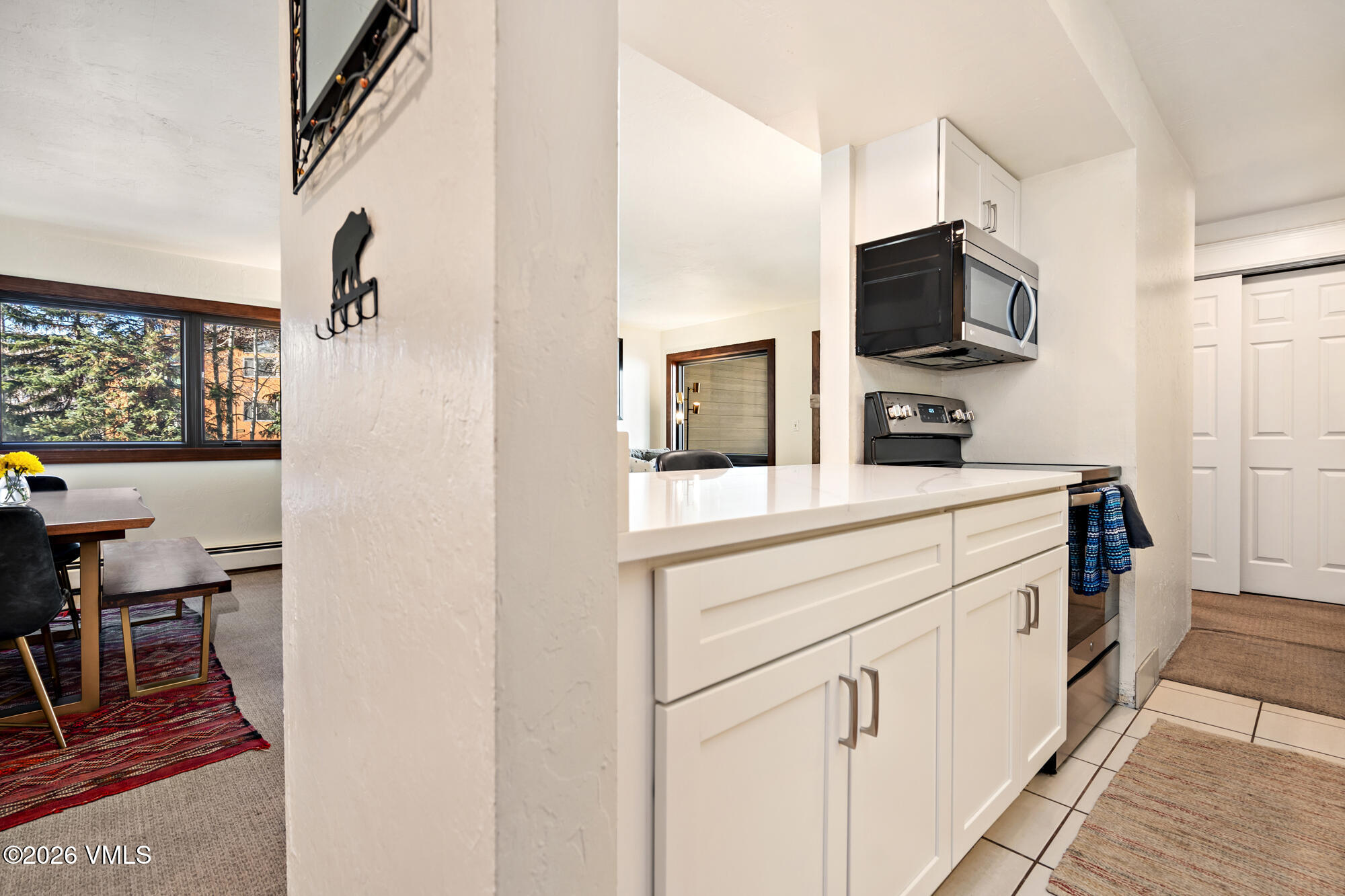 963 Lions Ridge Loop, Unit 502 Vail, CO 81657 - Photo 11 of 30 a kitchen with white cabinets and appliances