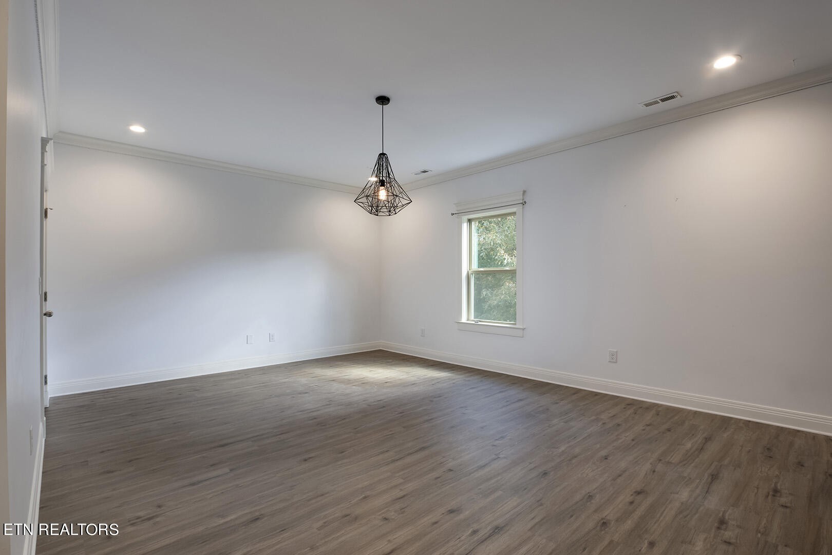 405 Beard Valley Road Maynardville, TN 37807 - Photo 35 of 60 an empty room with wooden floor chandelier and windows