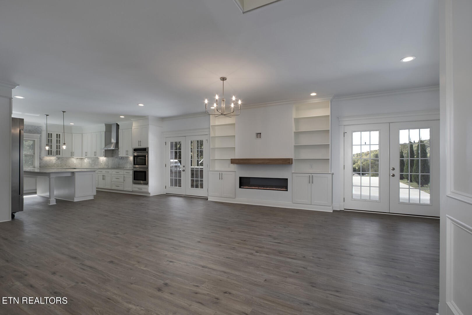 405 Beard Valley Road Maynardville, TN 37807 - Photo 5 of 60 a view of an empty room with wooden floor and a kitchen