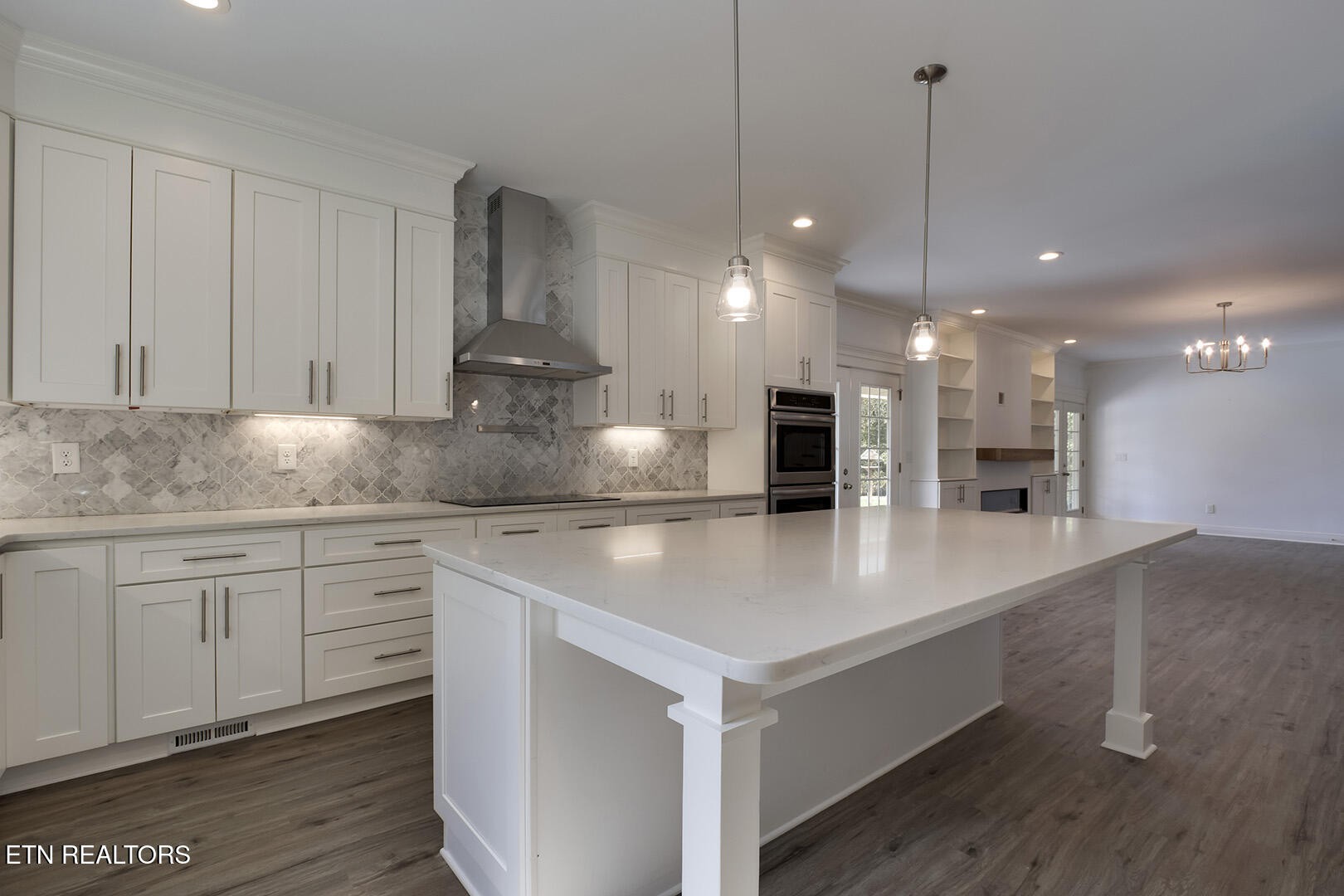 405 Beard Valley Road Maynardville, TN 37807 - Photo 10 of 60 a large kitchen with kitchen island a stove a sink a center island and wooden floor
