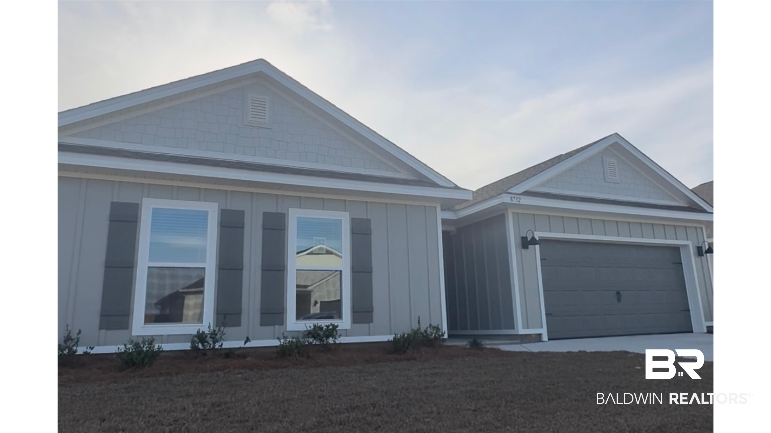 8732 Sea Star Circle Foley, AL 36535 - Photo 1 of 66 View of front facade featuring board and batten siding, an attached garage, and concrete driveway