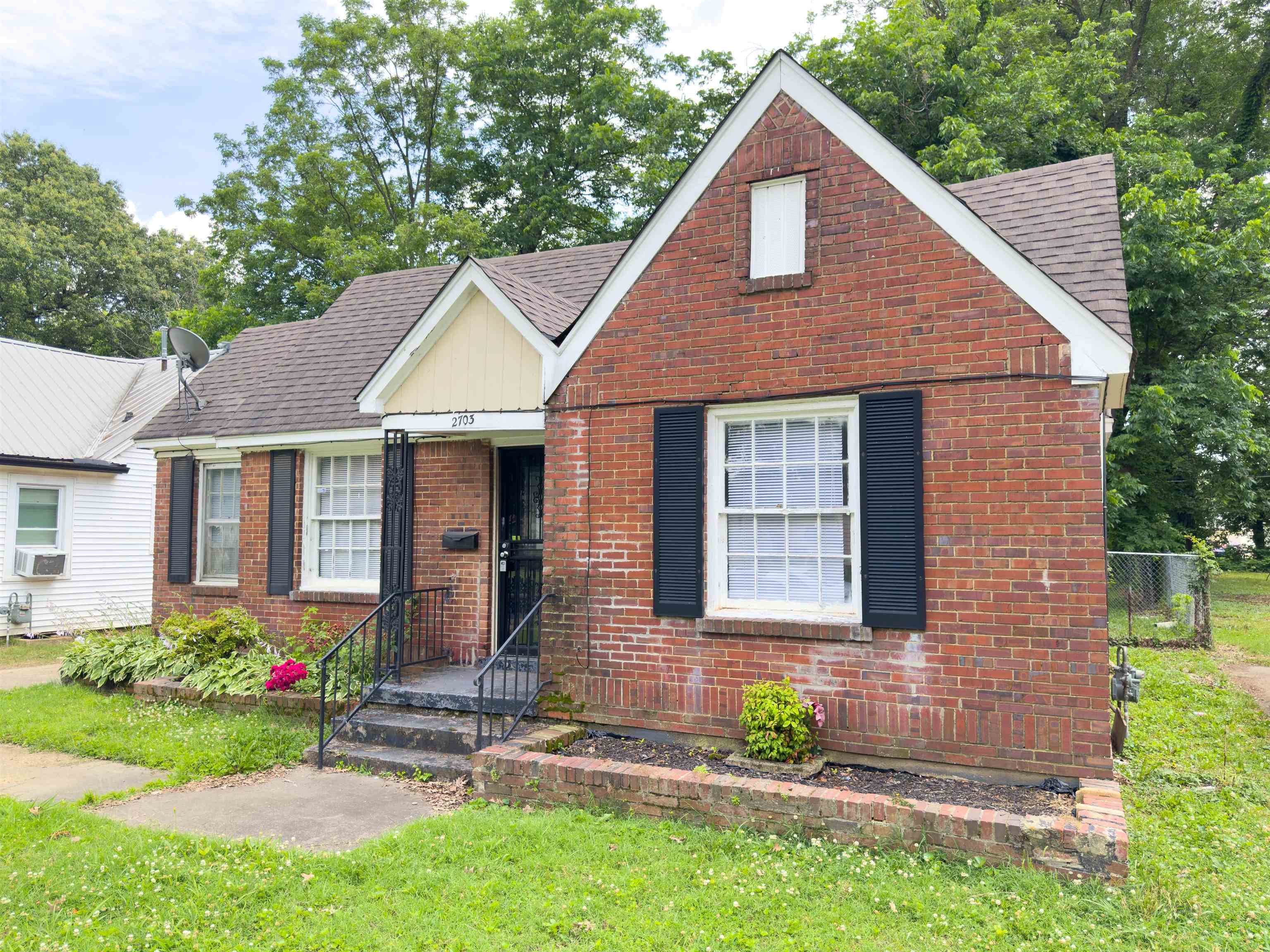 2703 Fizer Road Memphis, TN 38114 - Photo 3 of 19 English style home with a shingled roof and brick siding