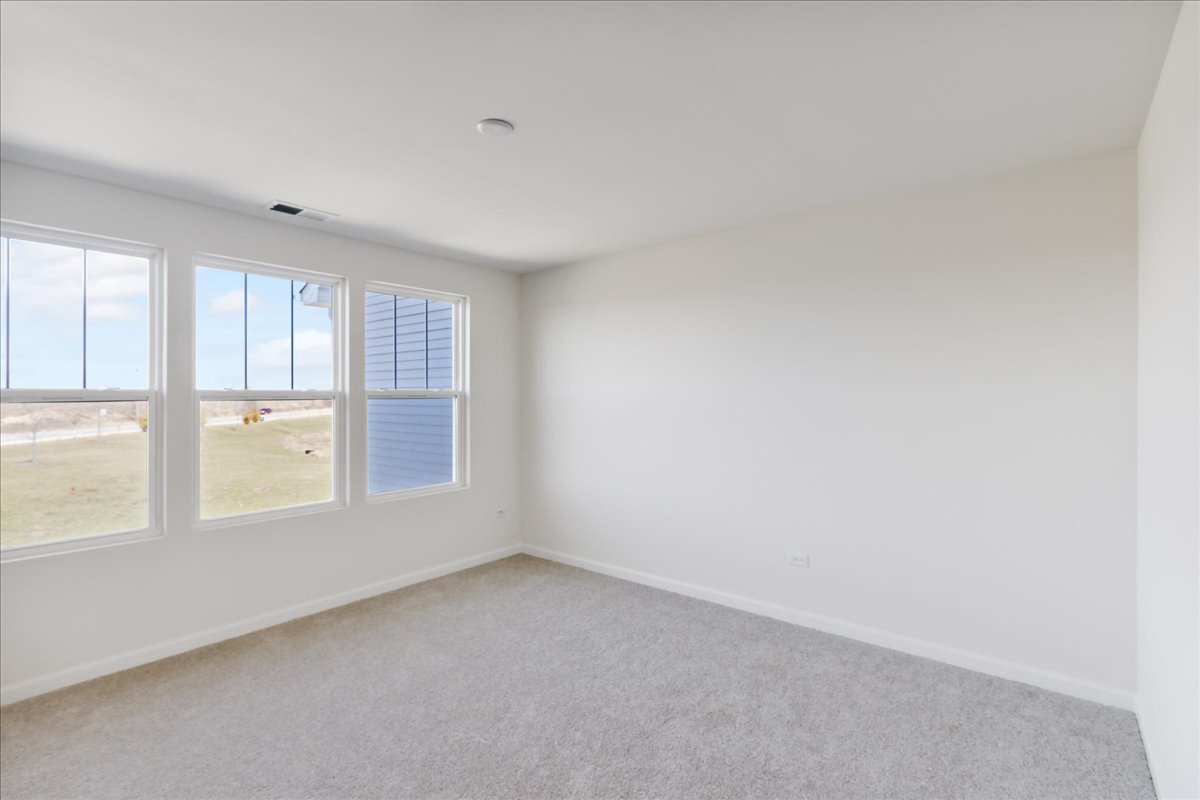 704 Switchgrass Way, Unit 56003 Bolingbrook, IL 60490 - Photo 19 of 29 an empty room with windows