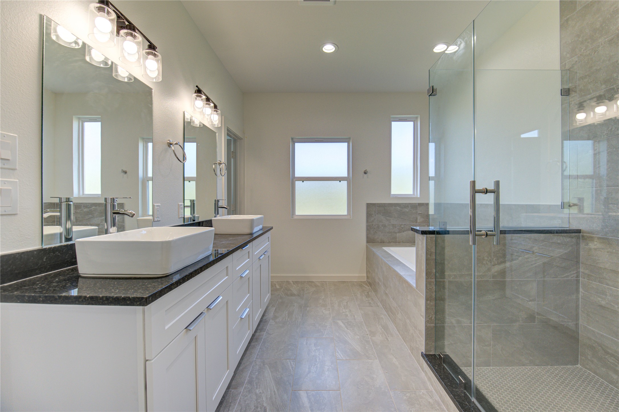 2903 El Fenice Lane Houston, TX 77057 - Photo 12 of 42 a bathroom with a granite countertop sink a large mirror and a shower