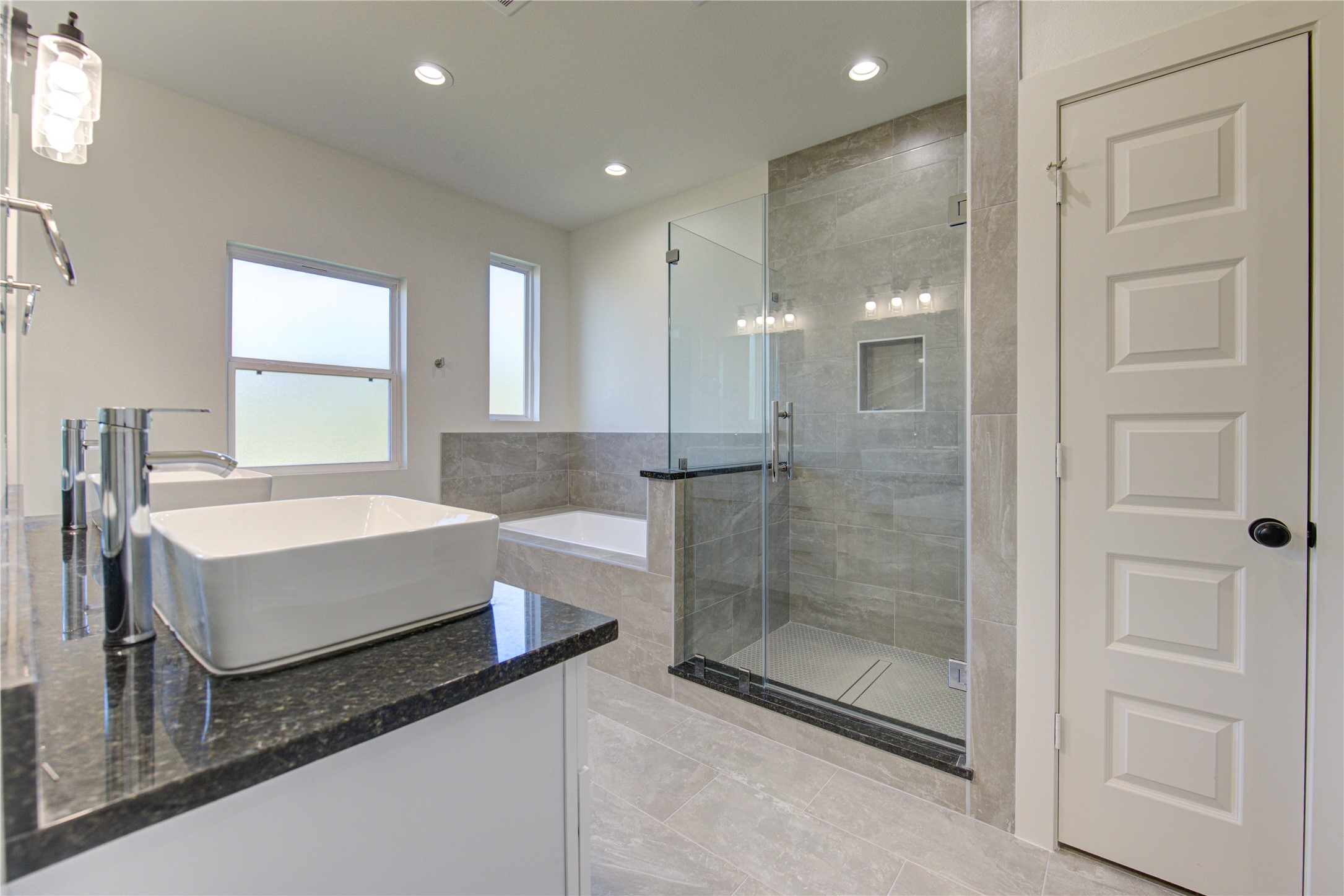 2903 El Fenice Lane Houston, TX 77057 - Photo 13 of 42 a bathroom with a granite countertop sink a mirror and a shower