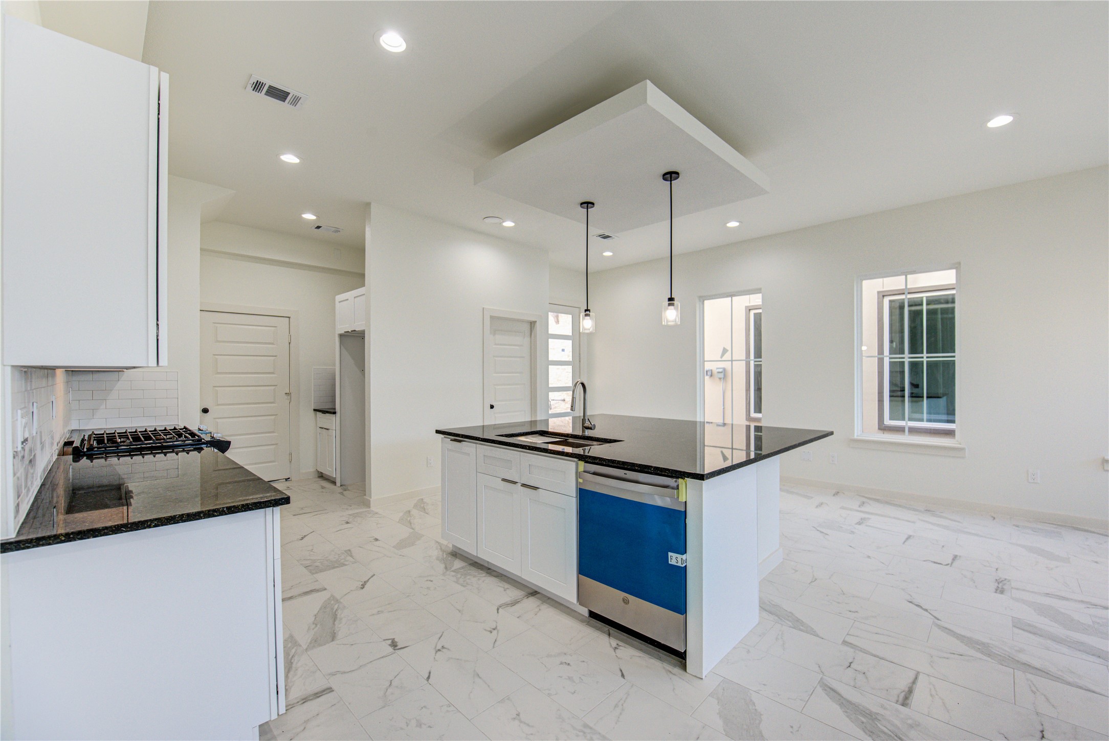 2903 El Fenice Lane Houston, TX 77057 - Photo 4 of 42 a kitchen with granite countertop kitchen island stainless steel appliances a sink a counter top space cabinets and a window