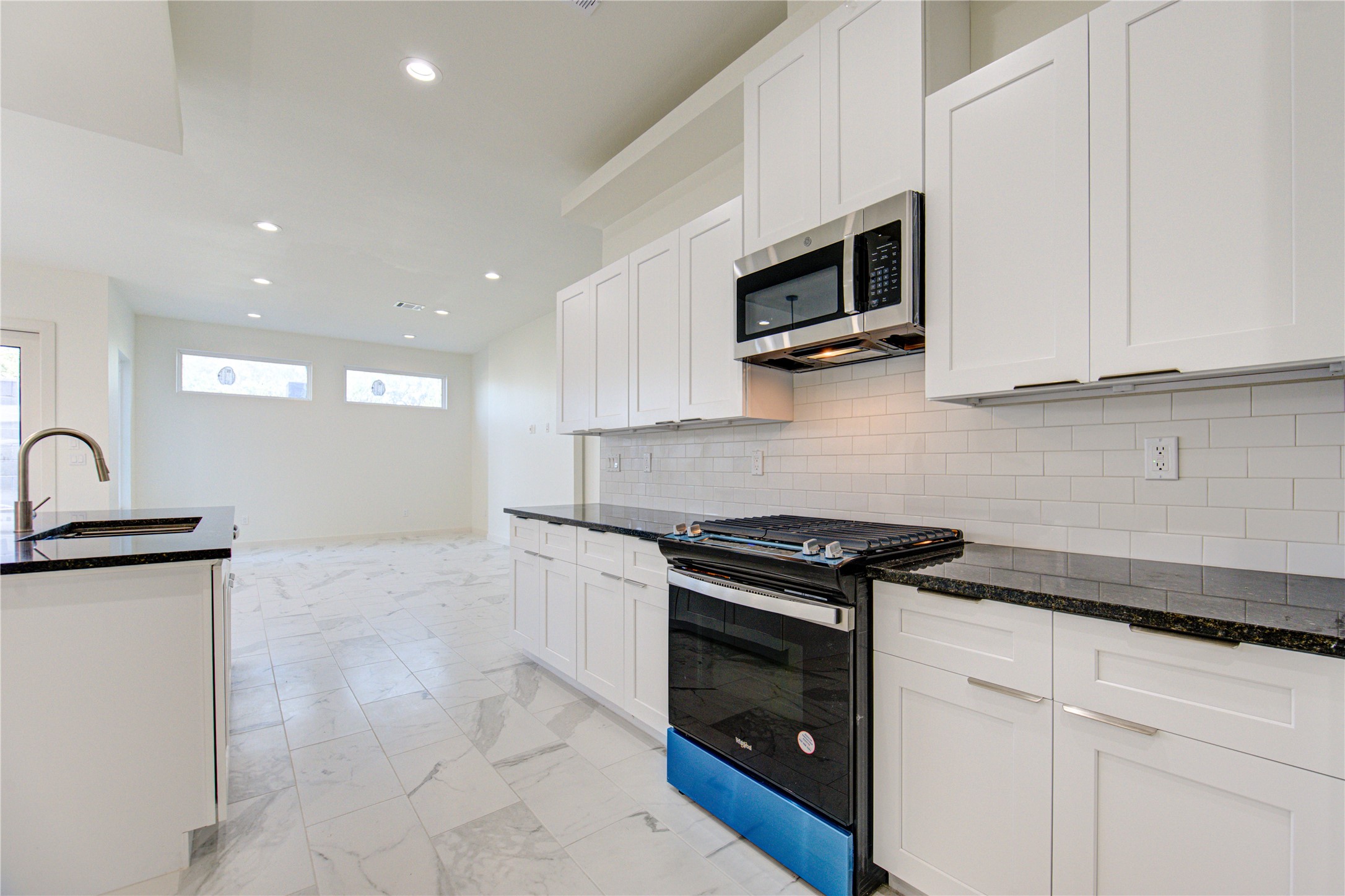 2903 El Fenice Lane Houston, TX 77057 - Photo 5 of 42 a kitchen with stainless steel appliances granite countertop a stove a microwave and a sink