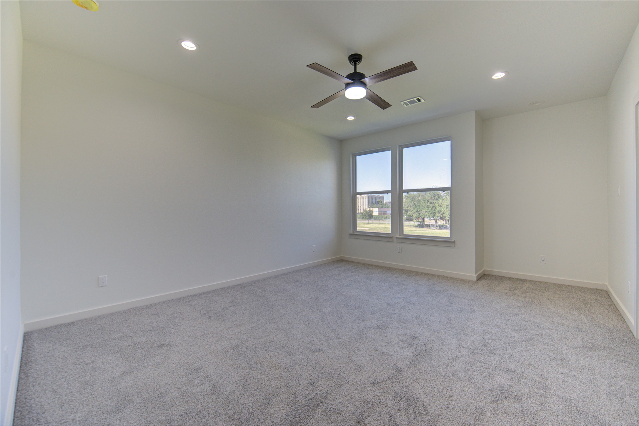 2903 El Fenice Lane Houston, TX 77057 - Photo 7 of 42 an empty room with windows and fan