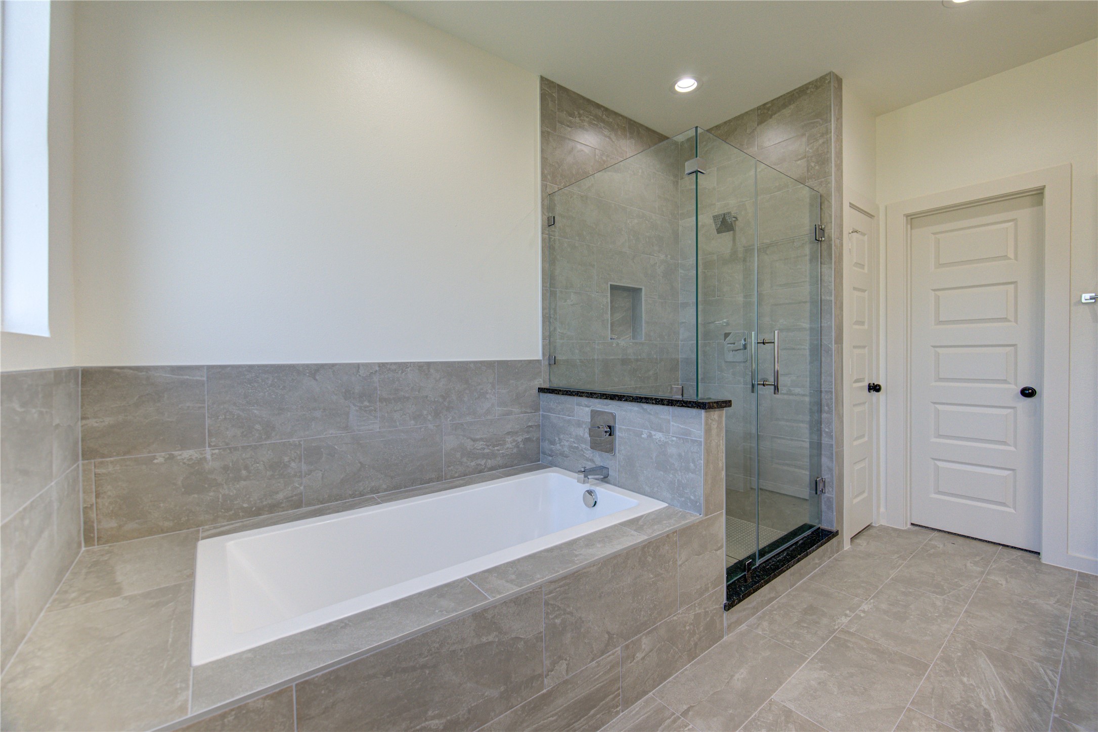 2903 El Fenice Lane Houston, TX 77057 - Photo 8 of 42 a bathroom with a bathtub and a shower