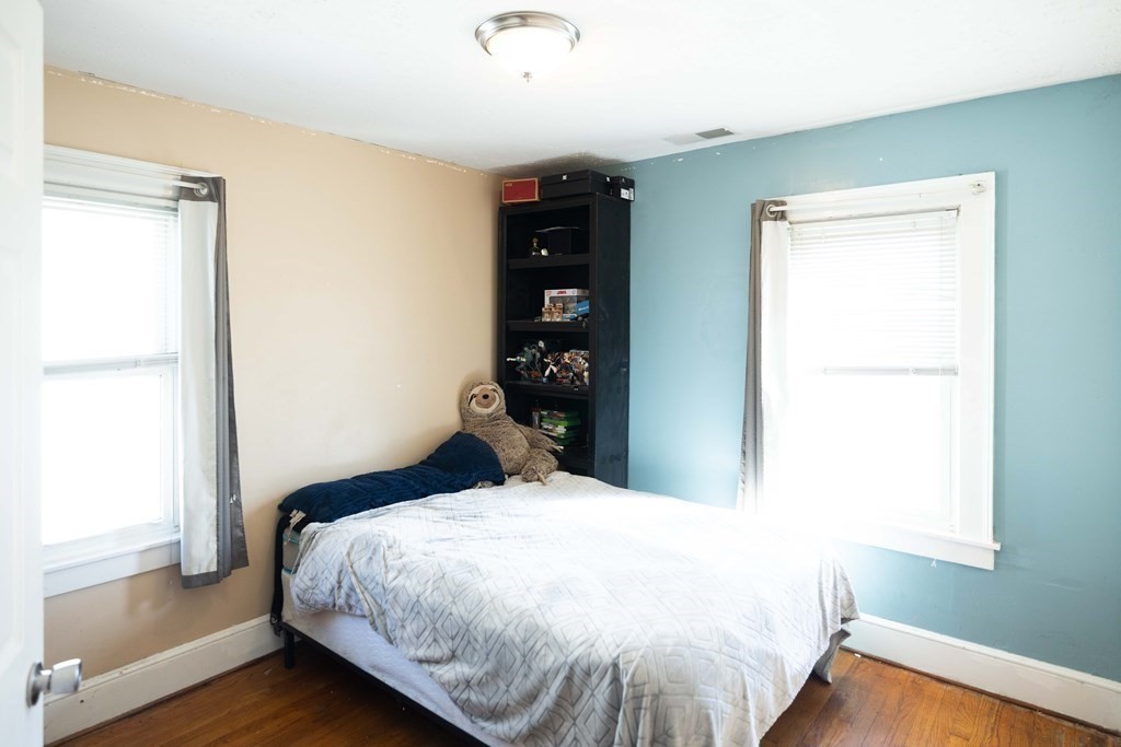 61 Dwight Road Springfield, MA 01108 - Photo 24 of 34 a bedroom with a bed and wooden floor
