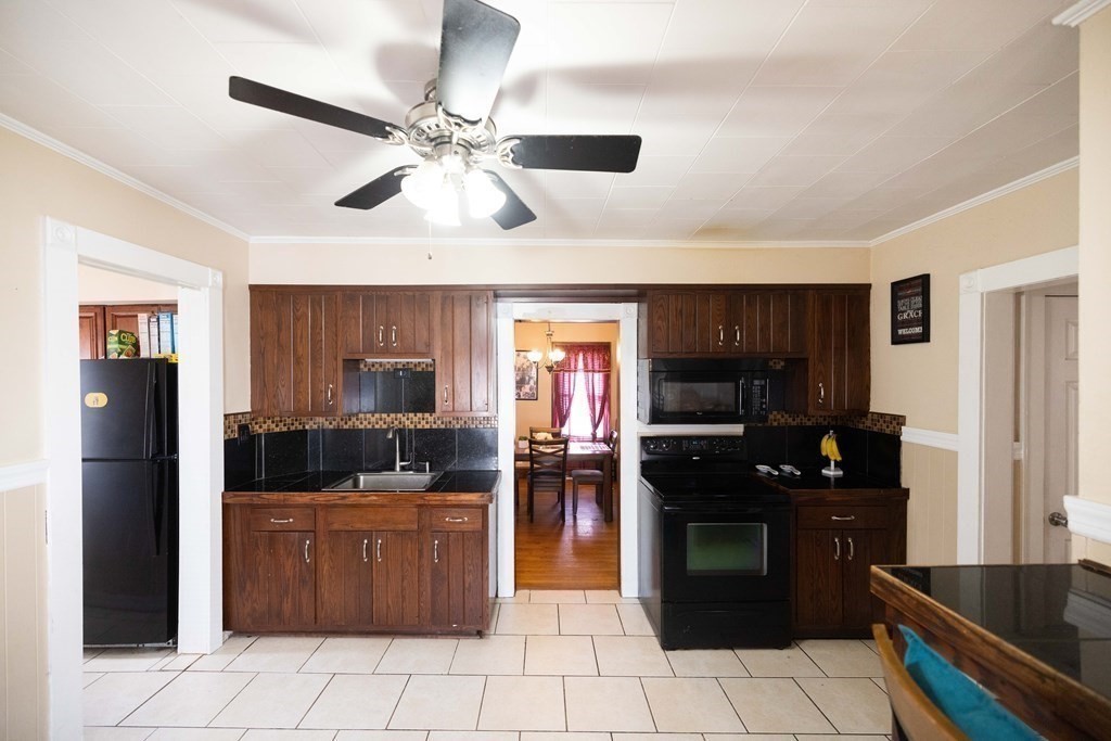 61 Dwight Road Springfield, MA 01108 - Photo 6 of 34 a kitchen with a refrigerator and a stove top oven