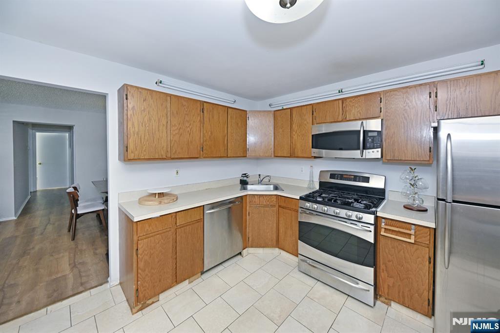 250 Larch Lane Mahwah, NJ 07430 - Photo 12 of 24 a kitchen with stainless steel appliances granite countertop a stove microwave and sink