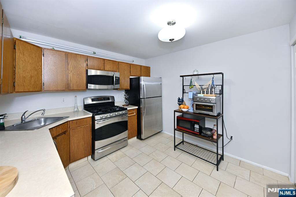 250 Larch Lane Mahwah, NJ 07430 - Photo 14 of 24 a kitchen with stainless steel appliances granite countertop a stove and a sink