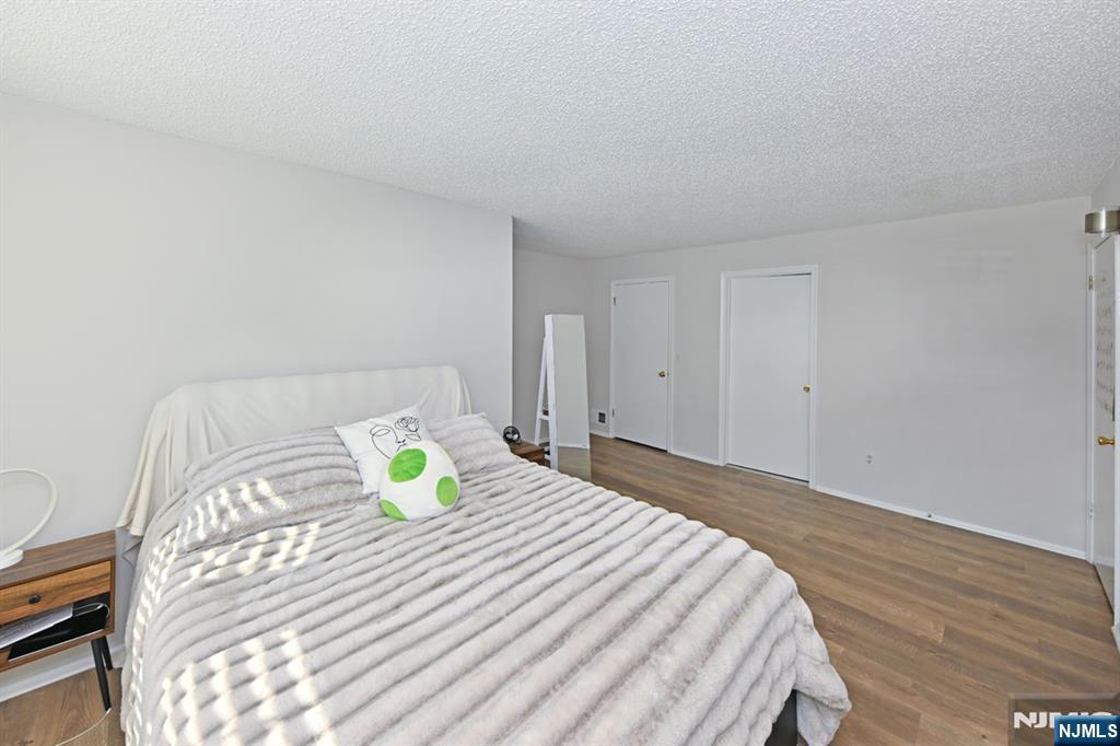 250 Larch Lane Mahwah, NJ 07430 - Photo 16 of 24 a bedroom with a bed and a lamp