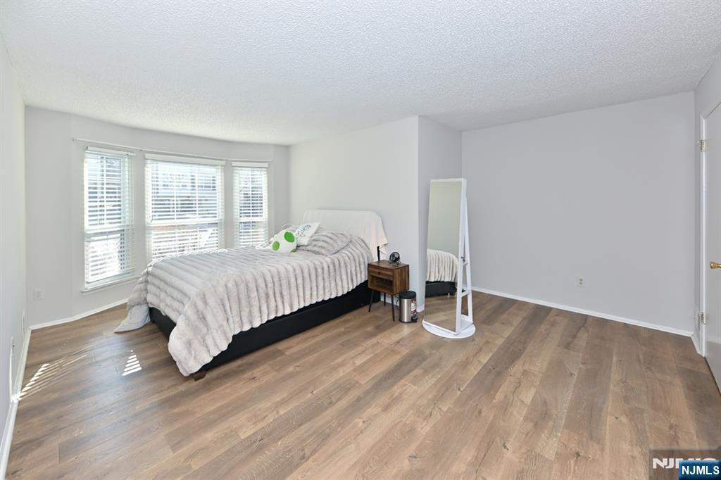 250 Larch Lane Mahwah, NJ 07430 - Photo 17 of 24 a bedroom with a bed and wooden floor