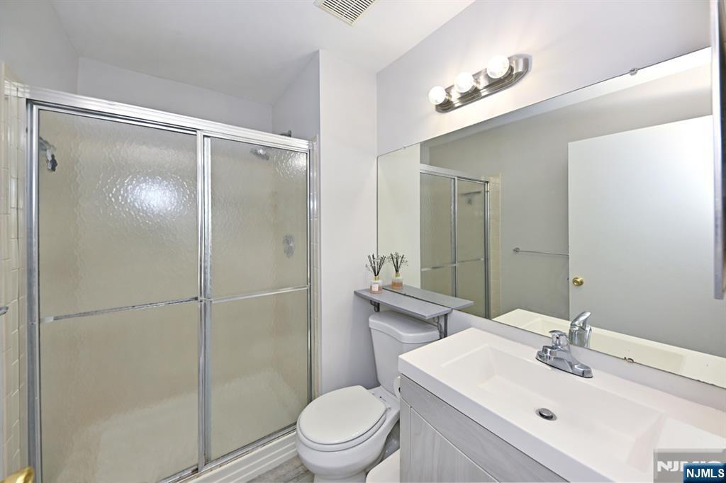 250 Larch Lane Mahwah, NJ 07430 - Photo 18 of 24 a bathroom with a sink mirror toilet and shower