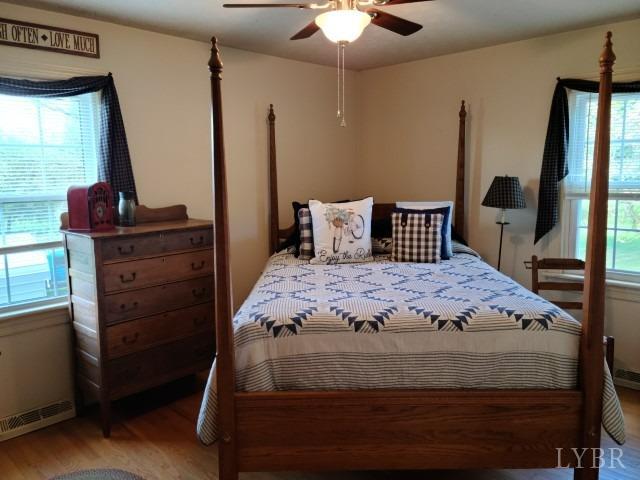 443 Wiggington Road Lynchburg, VA 24501 - Photo 14 of 42 a bedroom with a bed and a chandelier