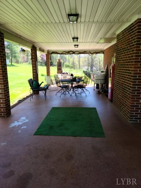 443 Wiggington Road Lynchburg, VA 24501 - Photo 26 of 42 a view of a patio with table and chairs potted plants with wooden fence