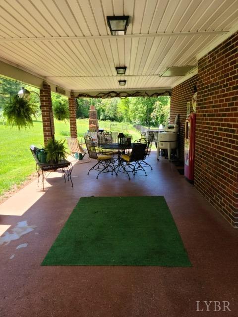 443 Wiggington Road Lynchburg, VA 24501 - Photo 42 of 42 a view of a patio with table and chairs under an umbrella with a patio