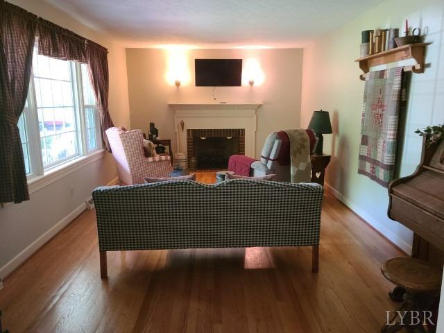 443 Wiggington Road Lynchburg, VA 24501 - Photo 7 of 42 a living room with furniture and a fireplace