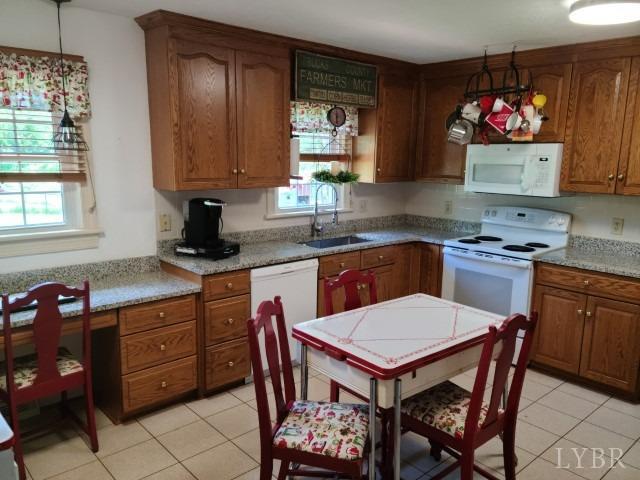 443 Wiggington Road Lynchburg, VA 24501 - Photo 9 of 42 a kitchen with a stove a sink and a refrigerator