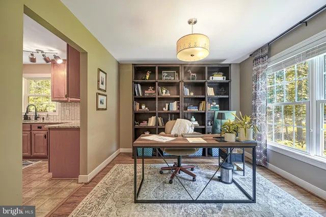 a living room with furniture a flat screen tv and dresser