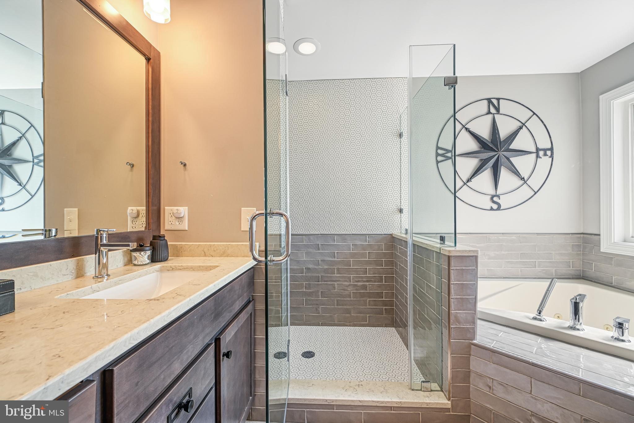 222 Battlefield Road Locust Grove, VA 22508 - Photo 21 of 84 a bathroom with a bathtub a mirror a vanity and a shower