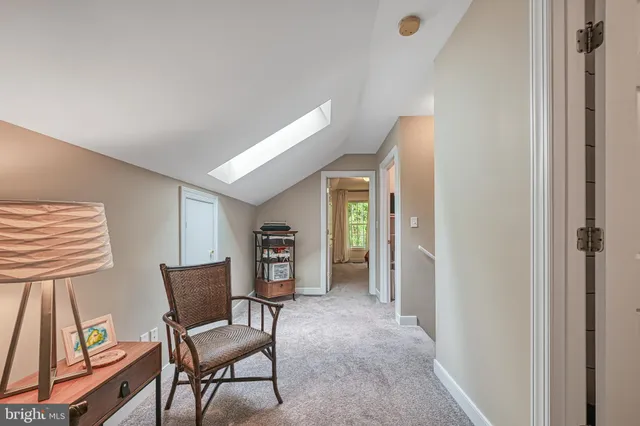 a view of house with a big yard and large tree