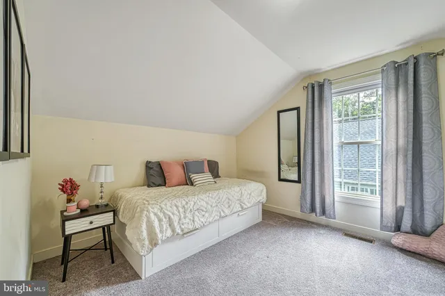 a front view of a house with yard and green space