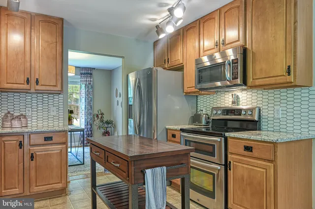 a spacious bedroom with a bed and wooden floor