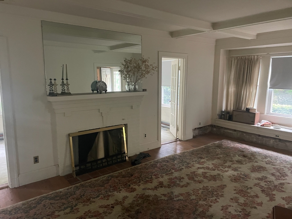 27 Greycliff Road Boston, MA 02135 - Photo 2 of 11 a view of a livingroom with a fireplace and window