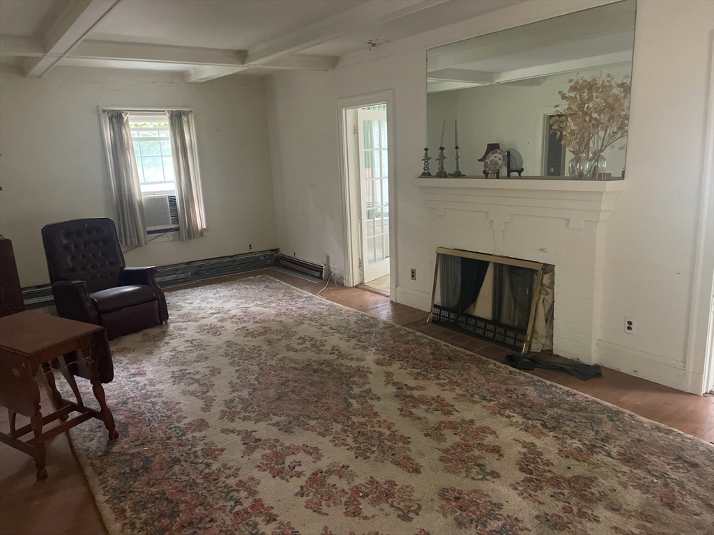 27 Greycliff Road Boston, MA 02135 - Photo 3 of 11 a living room with furniture and a fireplace