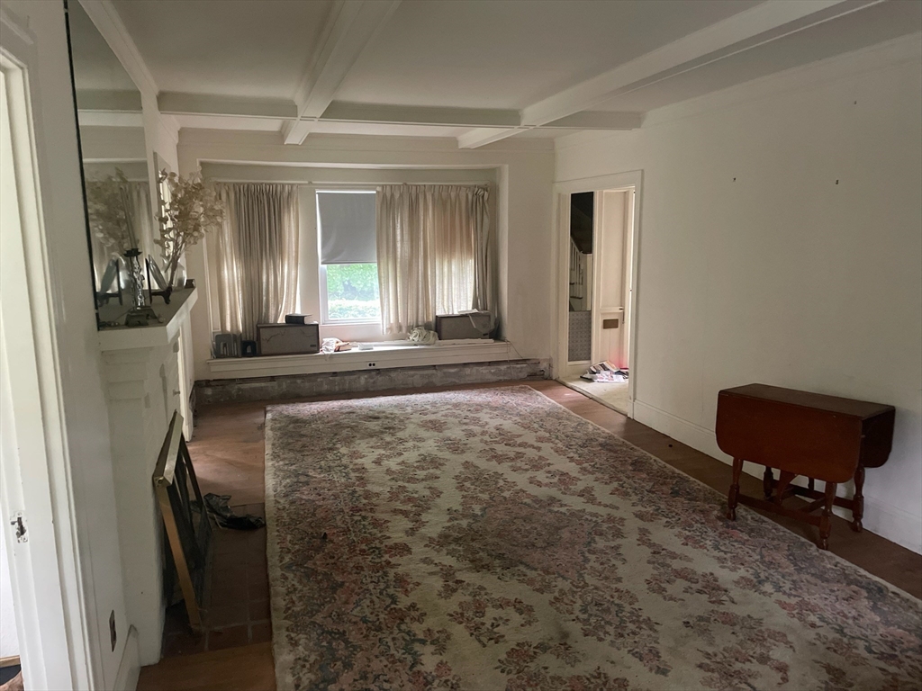 27 Greycliff Road Boston, MA 02135 - Photo 4 of 11 a view of a livingroom with furniture and a window