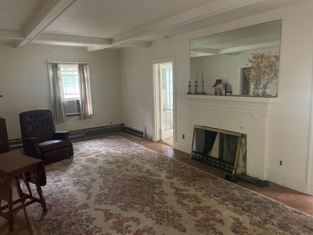 27 Greycliff Road Boston, MA 02135 - Photo 6 of 11 a living room with furniture and a fireplace