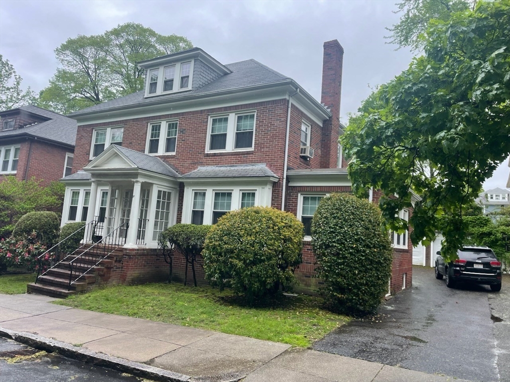 27 Greycliff Road Boston, MA 02135 - Photo 10 of 11 a front view of a house with a garden
