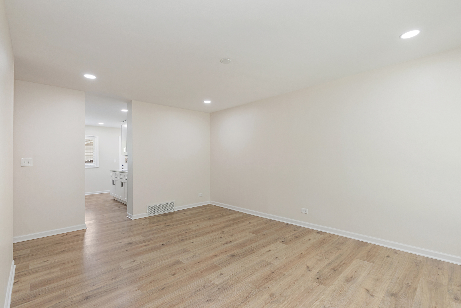 1101 Colony Court Streamwood, IL 60107 - Photo 4 of 16 a view of an empty room with wooden floor and a window