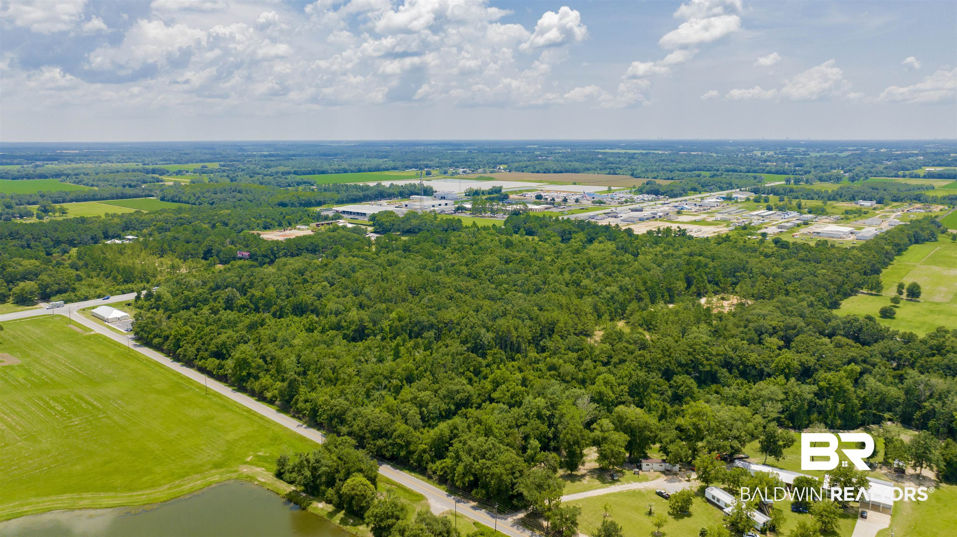 0 Vaughn Road Summerdale, AL 36580 - Photo 8 of 9 Aerial view of a forest and a large body of water