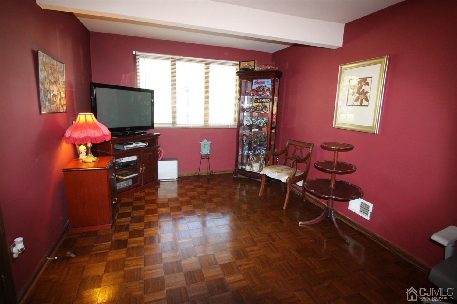 26 Homestead Road Edison, NJ 08820 - Photo 11 of 34 a room with furniture a flat screen tv and a window