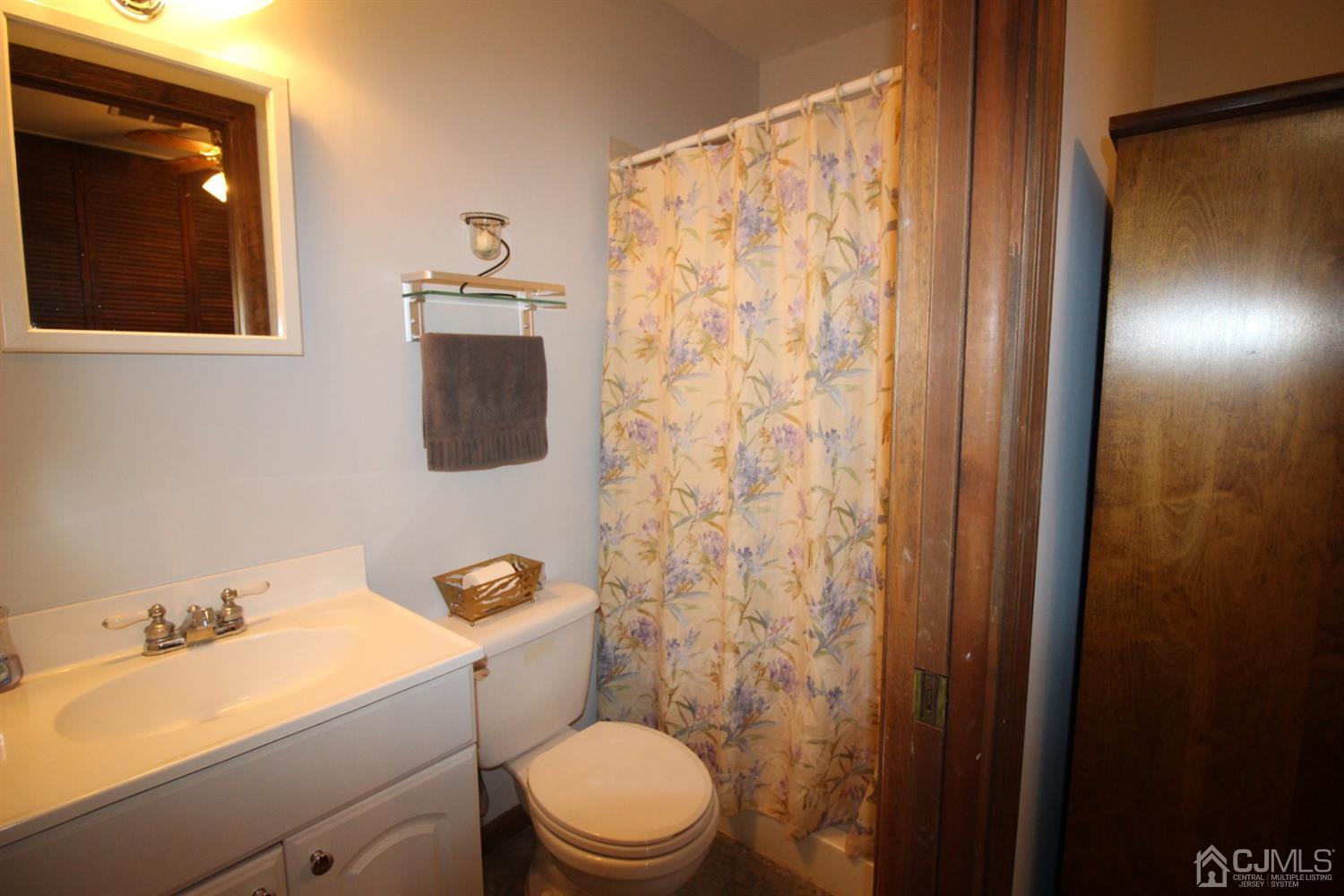 26 Homestead Road Edison, NJ 08820 - Photo 21 of 34 a bathroom with a sink a toilet and shower curtain