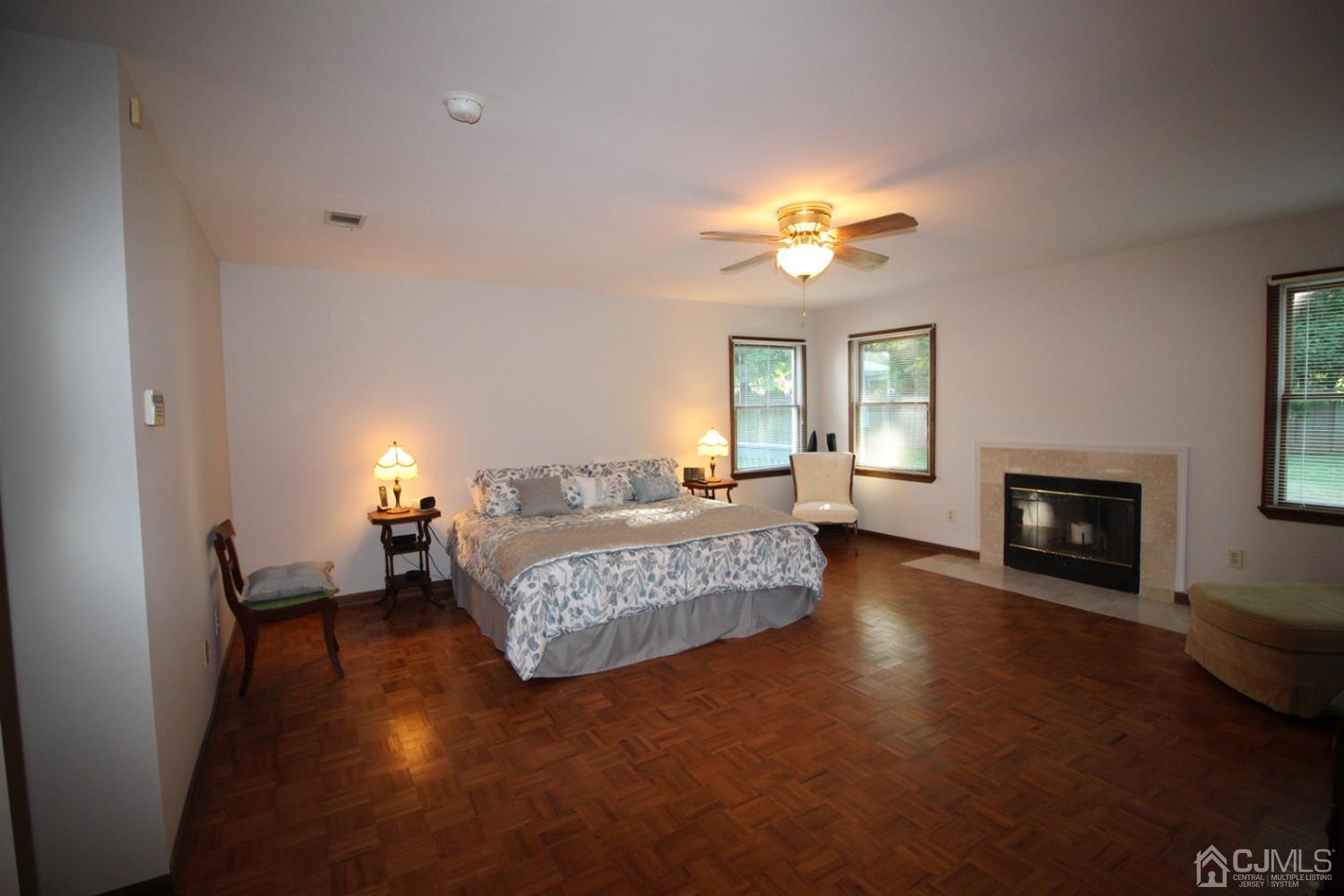 26 Homestead Road Edison, NJ 08820 - Photo 22 of 34 a spacious bedroom with a balcony a bed and a chandelier